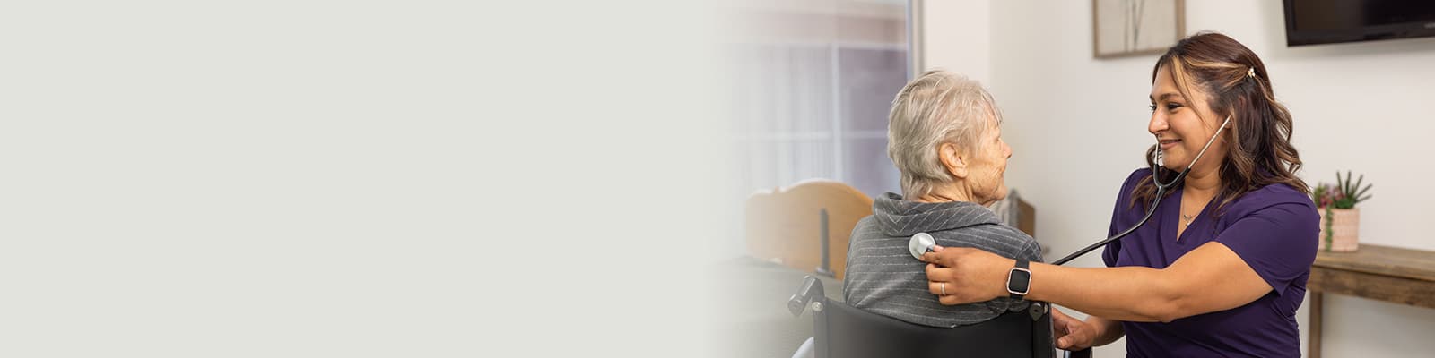A nurse helping a patient at San Jacinto Valley