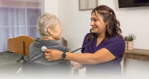 A nurse helping a patient at San Jacinto Valley