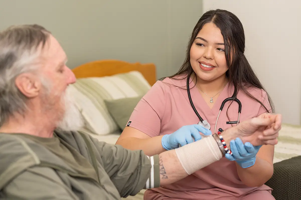 A nurse helping an elderly man at San Jacinto Valley