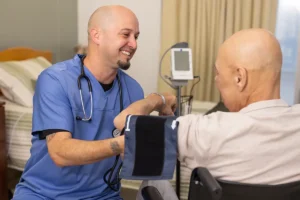 A nurse taking an elderly man's blood pressure at San Jacinto Valley