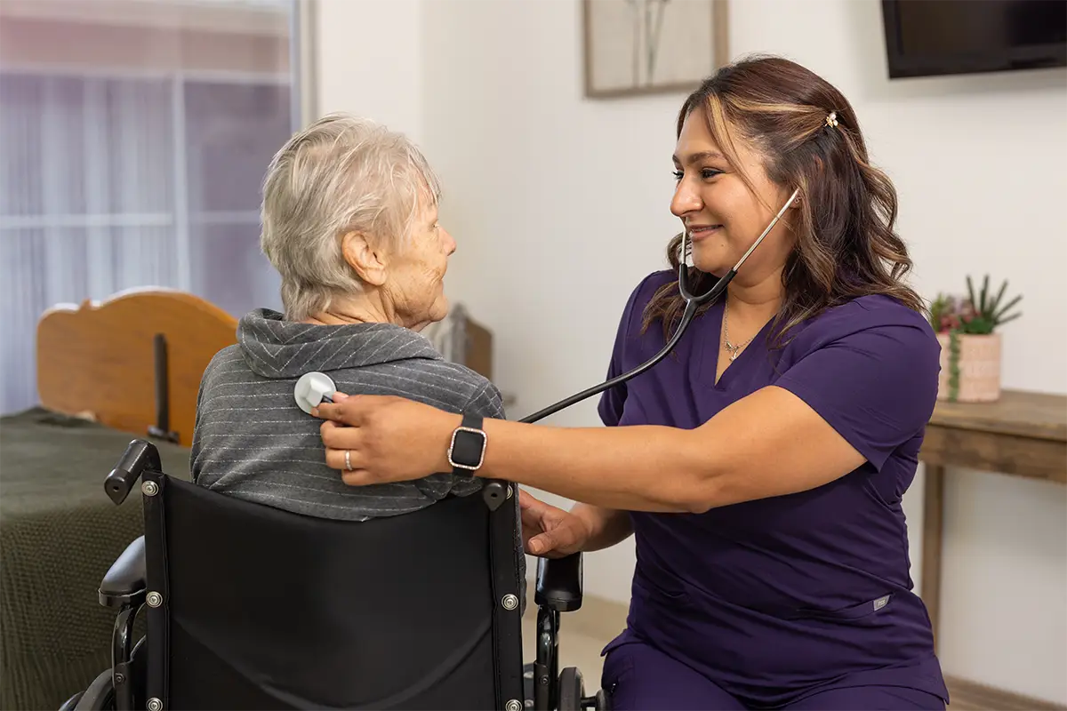 A nurse getting a patients heartbeat at San Jacinto Valley