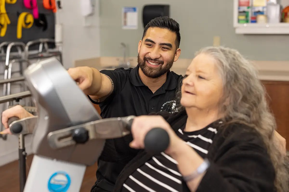 A physical therapist helping a woman at San Jacinto Valley