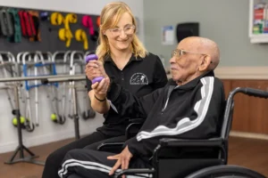 A physical therapist helping an elderly man at San Jacinto Valley