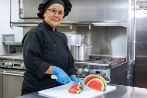 A chef cutting watermelon at San Jacinto Valley